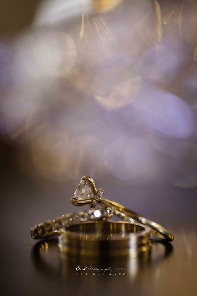 Close-up of wedding rings with bokeh lighting, Houston wedding photography