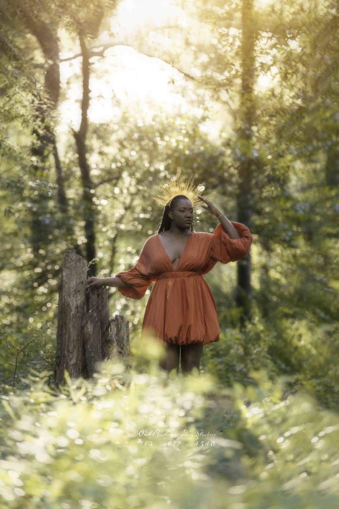 Outdoor portrait of woman in red dress in sunlit forest, Houston portrait photography