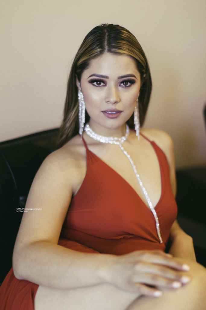 Portrait of woman in red dress with statement jewelry, Houston photography studio