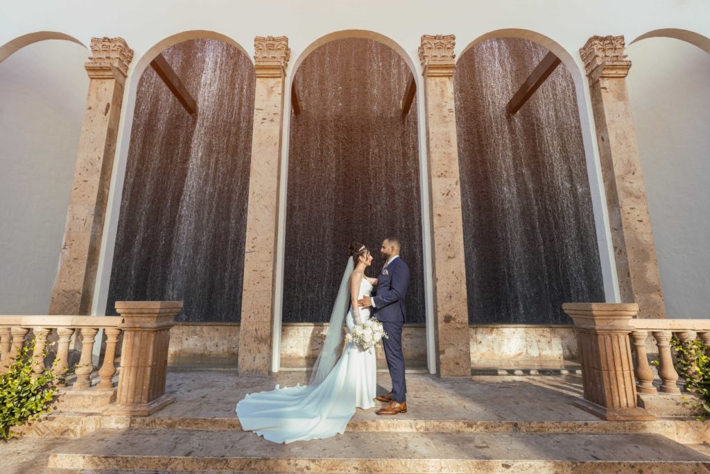 Bride and groom on stone staircase at wedding venue