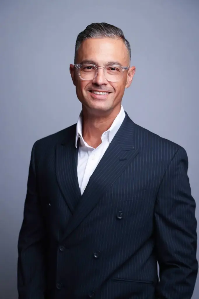 Corporate headshot of man in navy suit with glasses, Houston business photography
