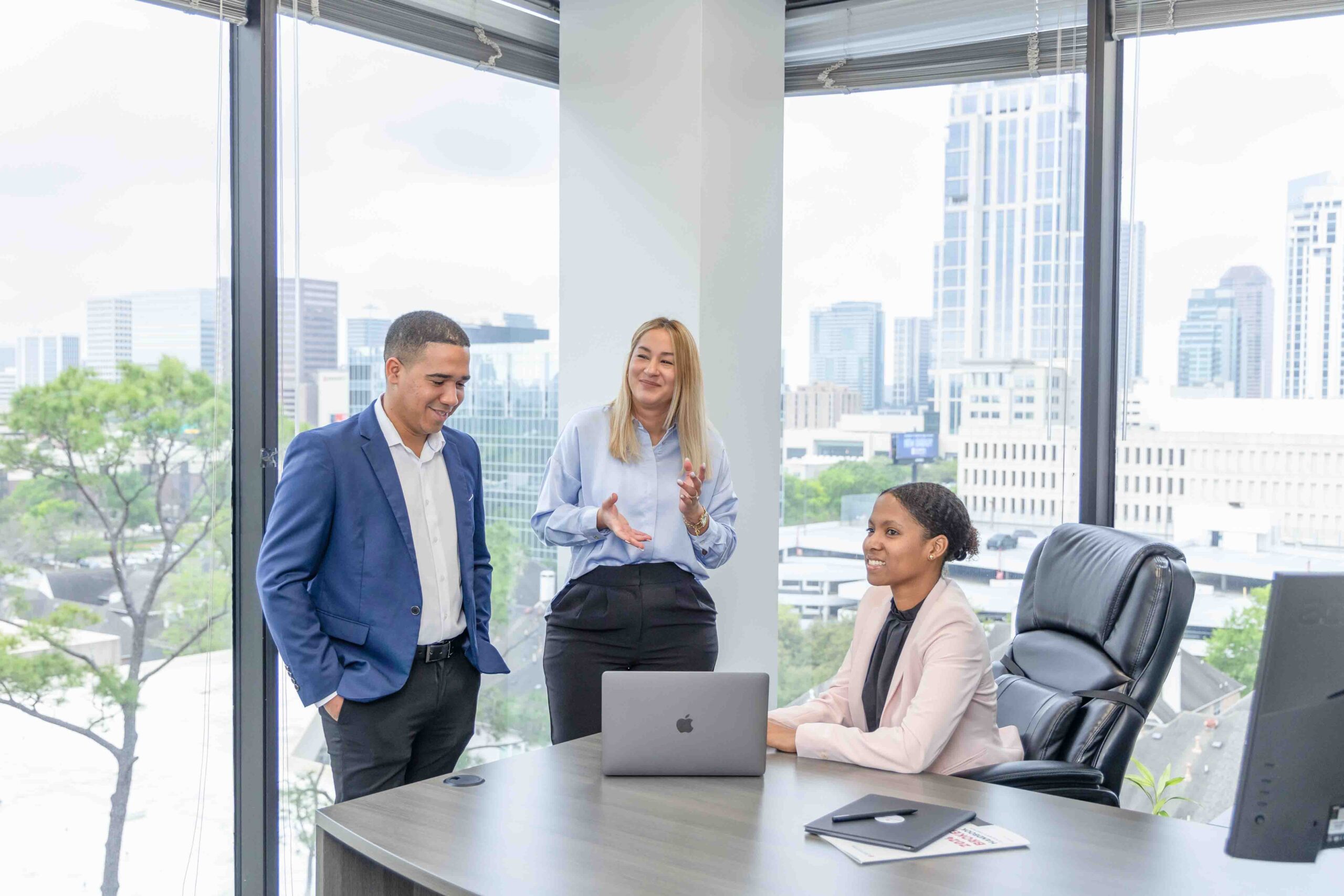 Business professionals in meeting at office with city view, Houston corporate photography