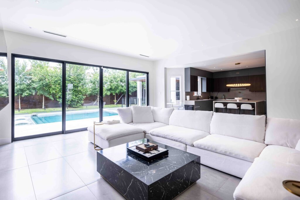 Living room with floor-to-ceiling windows overlooking pool, Houston real estate photography