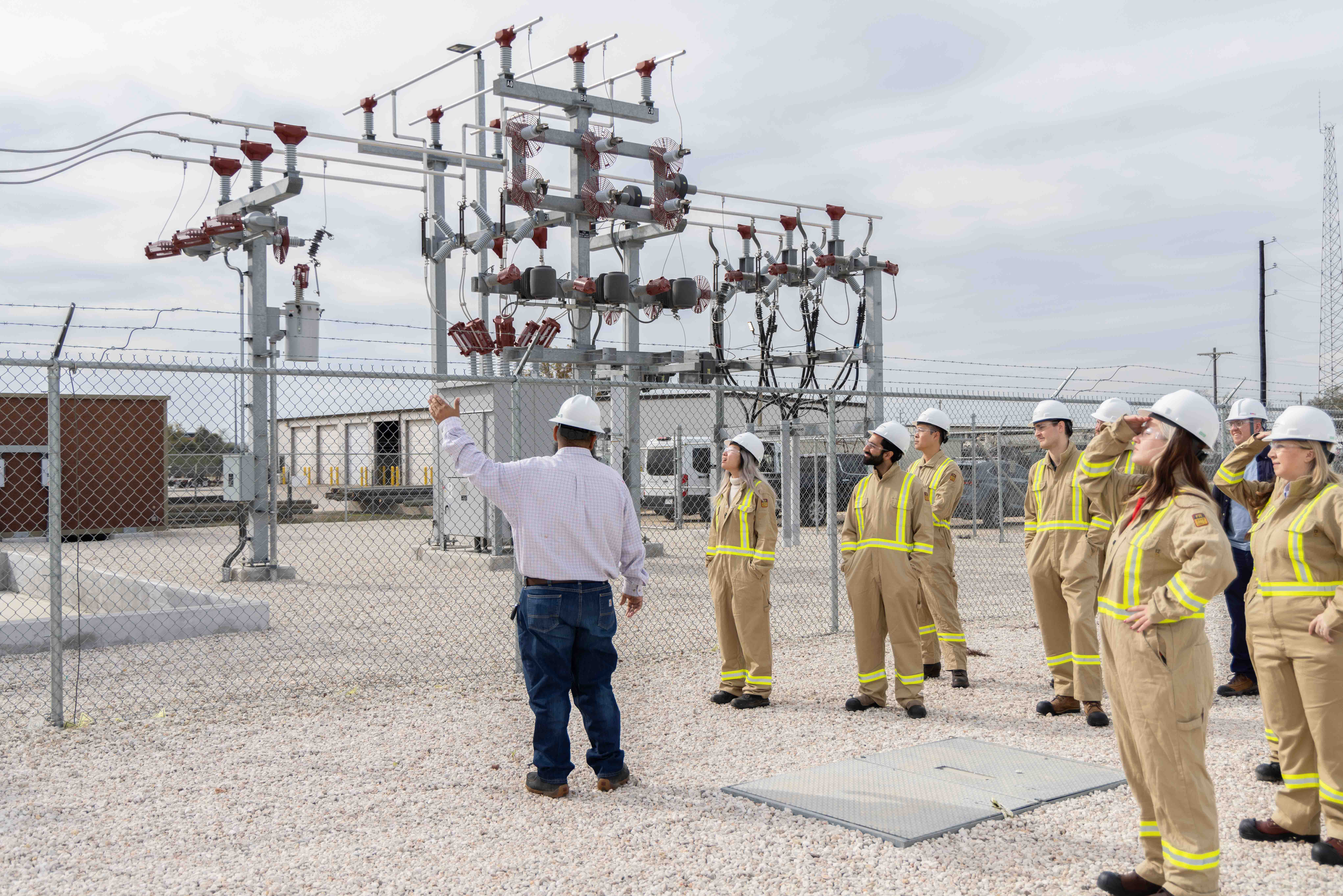 Utility workers in safety gear inspecting power infrastructure, Houston industrial photography