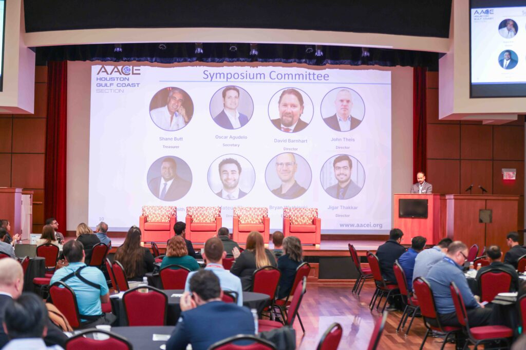 Symposium panel discussion with speaker headshots on screen, Houston corporate event photography
